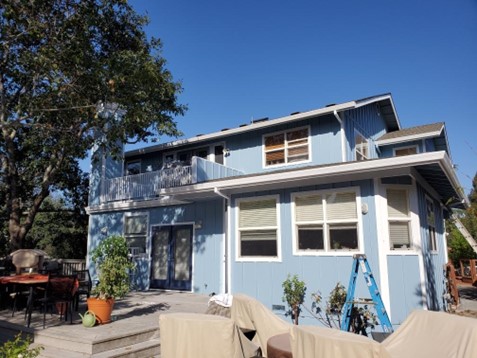 A home that has been newly painted with blue and white.