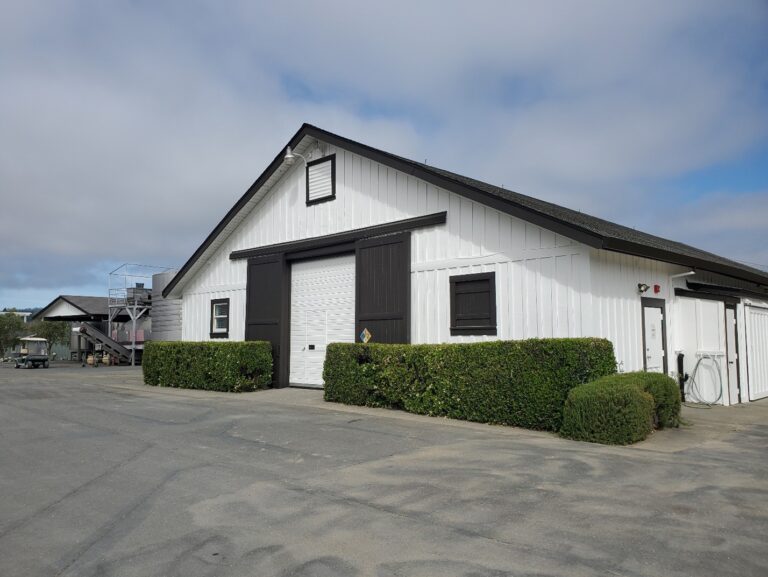 The exterior of a winery building, freshly painted a modern black and white scheme.