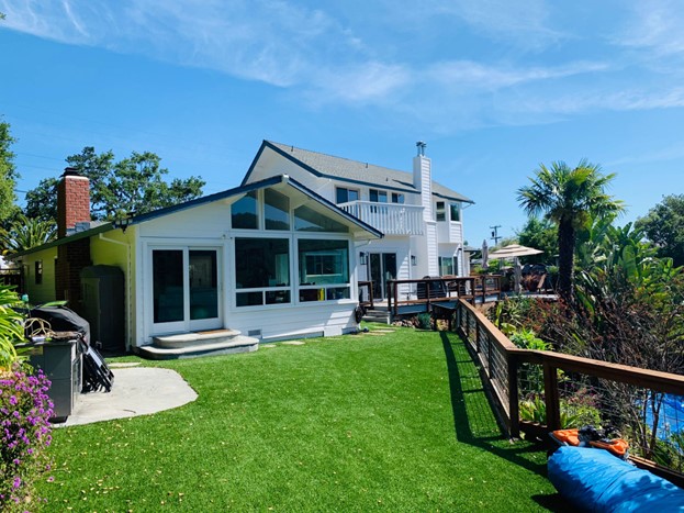 A modern home painted with fresh white paint and black trim.