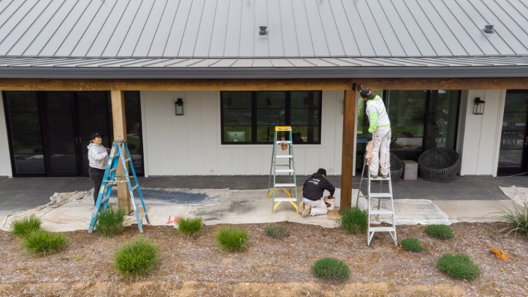 Painters working on the exterior of a residential building