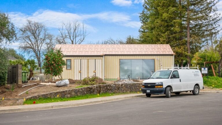 The exterior of a newly painted home with a Mike Chavez Painting van outside