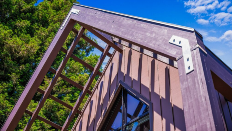 A commercial building with intricate wood beams freshly painted