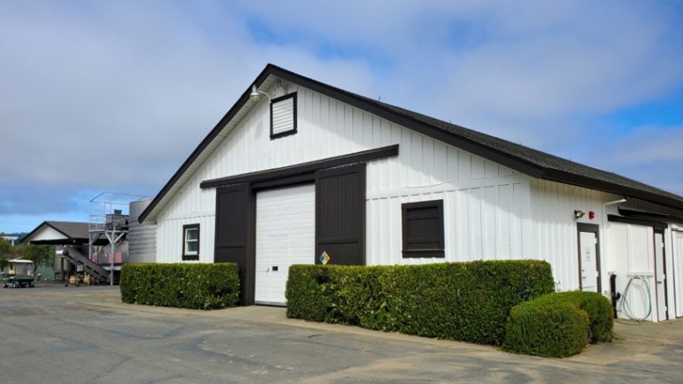 The exterior of a commercial building that has been newly painted white and black