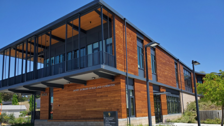 The exterior of a commercial building with wooden siding that has been newly stained