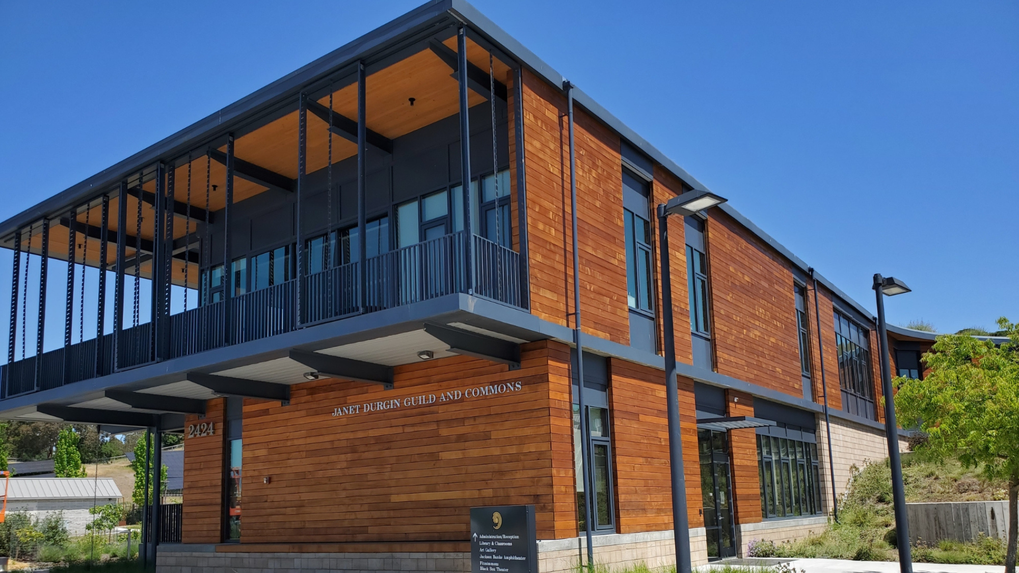The exterior of a commercial building with wooden siding that has been newly stained