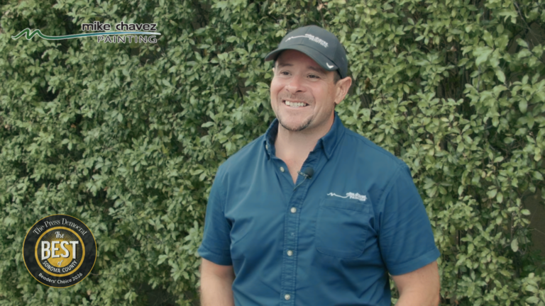 Mike Chavez, owner of Mike Chavez Painting, smiles during an interview.